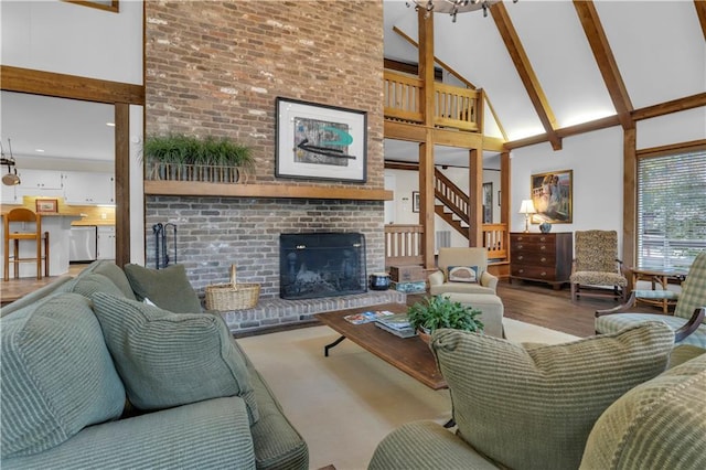 living room with beam ceiling, a brick fireplace, and high vaulted ceiling