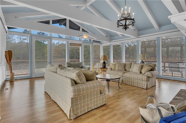 sunroom / solarium featuring a chandelier and lofted ceiling with beams