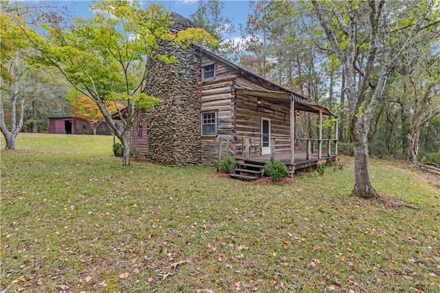 view of side of home featuring a yard and a deck