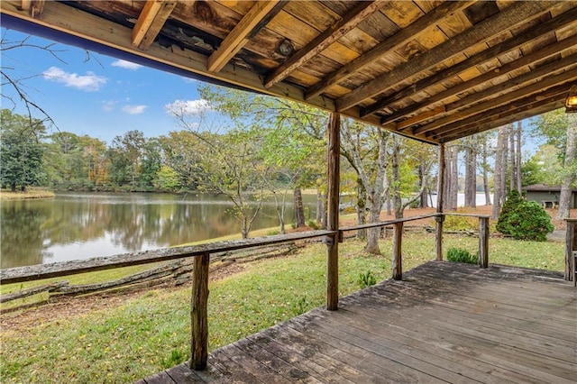 wooden terrace featuring a water view