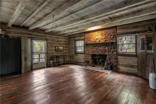 unfurnished living room featuring wood ceiling, a wealth of natural light, and dark wood-type flooring