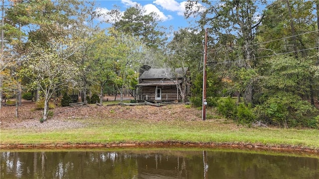 back of property featuring a water view