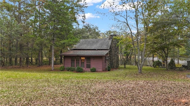 view of outbuilding featuring a yard