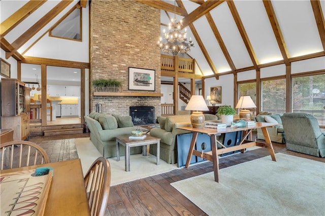 living room featuring an inviting chandelier, high vaulted ceiling, a brick fireplace, dark hardwood / wood-style flooring, and beam ceiling