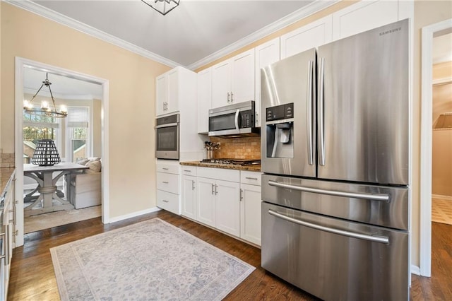 kitchen with tasteful backsplash, white cabinetry, stainless steel appliances, and ornamental molding