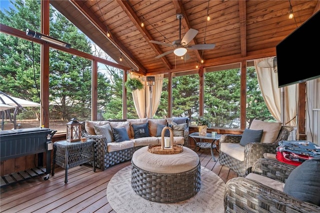 sunroom featuring lofted ceiling with beams, wooden ceiling, and ceiling fan