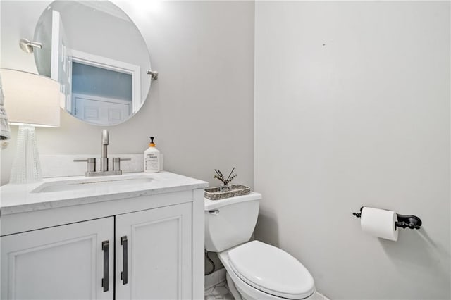 bathroom featuring toilet and vanity