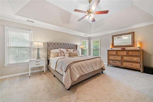 bedroom featuring baseboards, visible vents, a raised ceiling, and light carpet