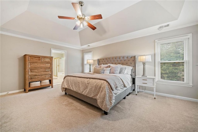 bedroom with multiple windows, crown molding, and a raised ceiling