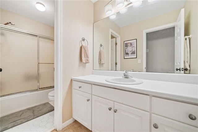 bathroom featuring enclosed tub / shower combo, toilet, and vanity