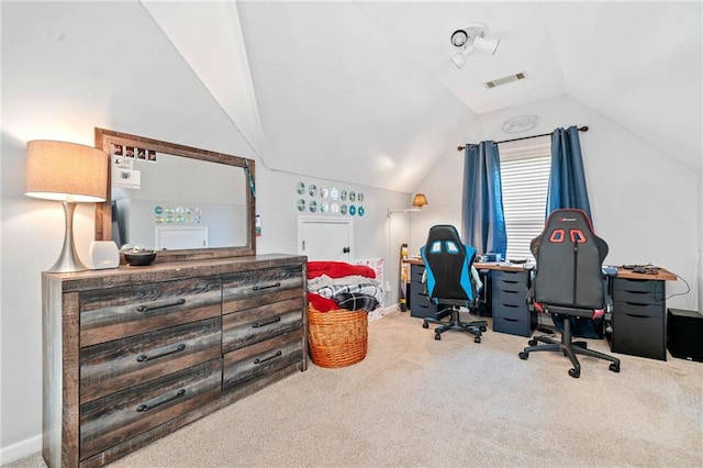 carpeted office space featuring vaulted ceiling, baseboards, and visible vents