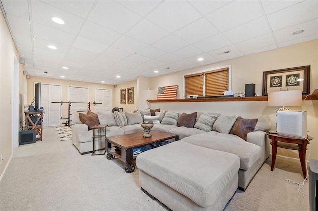 living area with recessed lighting, a paneled ceiling, and carpet