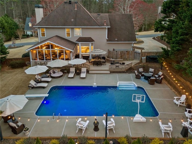 rear view of house featuring outdoor dining space, an outdoor hangout area, a wooden deck, and a fenced backyard