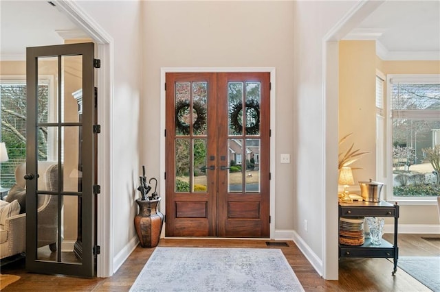 entrance foyer featuring a wealth of natural light, french doors, and wood finished floors