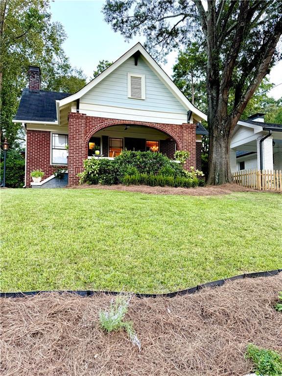 1670 Rogers Ave SW, Atlanta, GA 30310 - view of front of house with brick siding, a chimney, a front yard, and fence