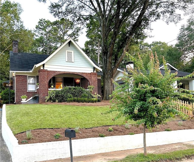 1670 Rogers Ave SW, Atlanta, GA 30310 - view of front of home with a front yard, fence, brick siding, and a chimney
