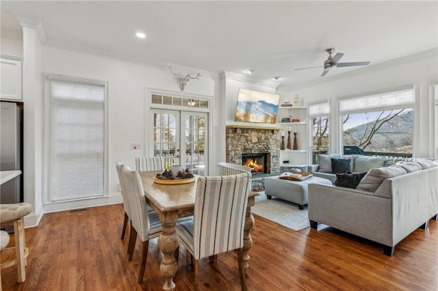 dining room with crown molding, hardwood / wood-style flooring, a wealth of natural light, and ceiling fan