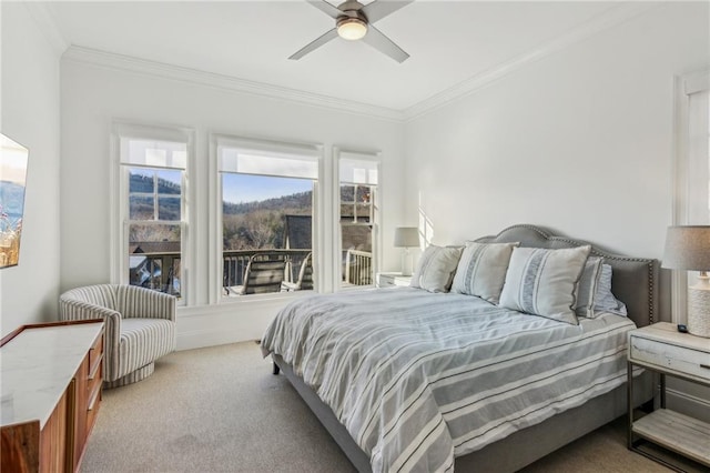 carpeted bedroom featuring ceiling fan and ornamental molding