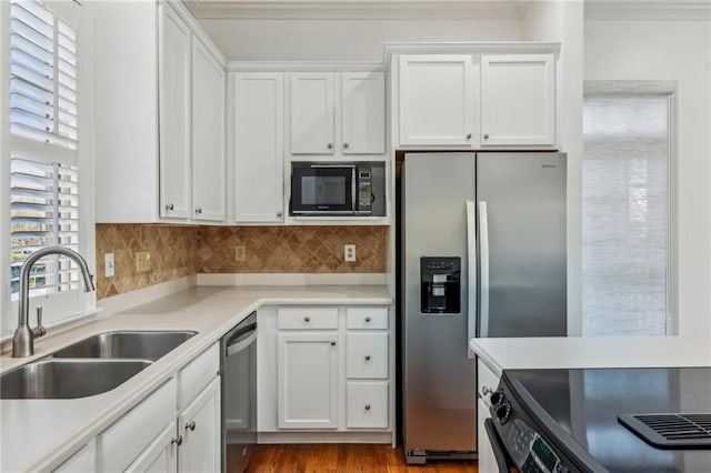 kitchen with sink, white cabinets, stainless steel appliances, and a healthy amount of sunlight