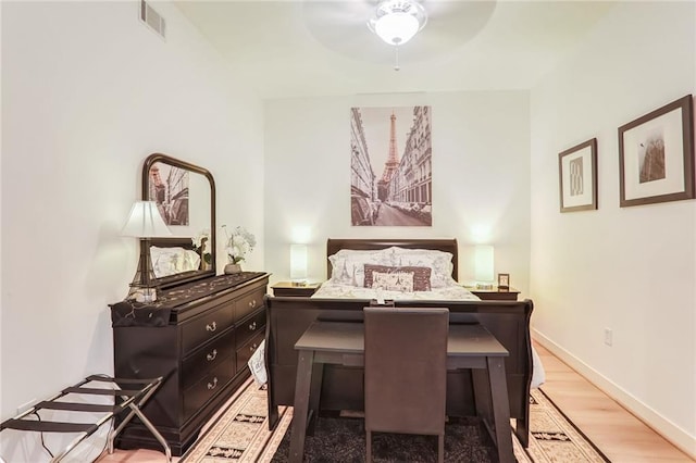 bedroom with light wood-type flooring, baseboards, and visible vents