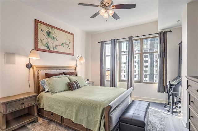 bedroom featuring light wood-style floors, ceiling fan, and baseboards