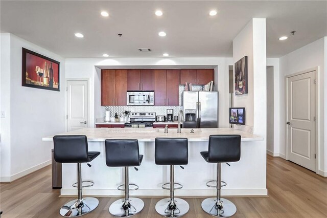 565 Peachtree St NE Unit 1303, Atlanta, GA 30308 - kitchen with light countertops, a sink, tasteful backsplash, stainless steel appliances, and visible vents