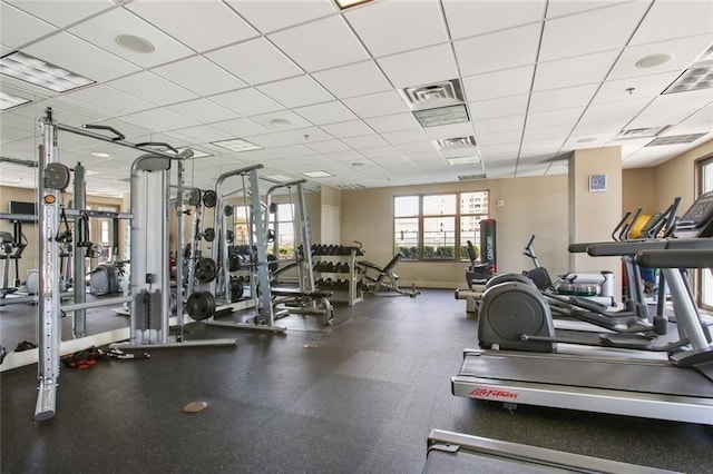 gym featuring a drop ceiling, visible vents, and baseboards