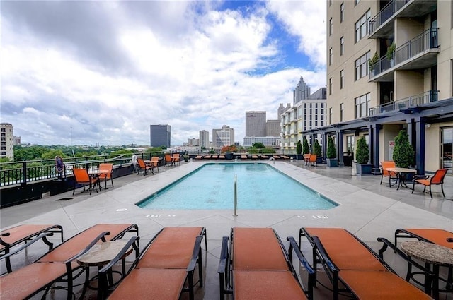 community pool featuring a city view and a patio