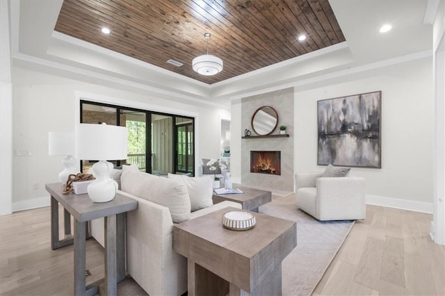 5990 Watermark Cv, Gainesville, GA 30506 - living room featuring a tray ceiling, wooden ceiling, baseboards, a premium fireplace, and light wood finished floors