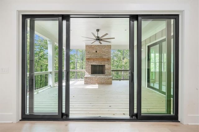 5990 Watermark Cv, Gainesville, GA 30506 - doorway to outside with a ceiling fan, an outdoor stone fireplace, and wood finished floors