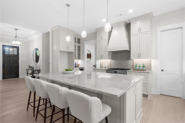 5990 Watermark Cv, Gainesville, GA 30506 - kitchen featuring premium range hood, decorative backsplash, light wood-type flooring, white cabinets, and recessed lighting