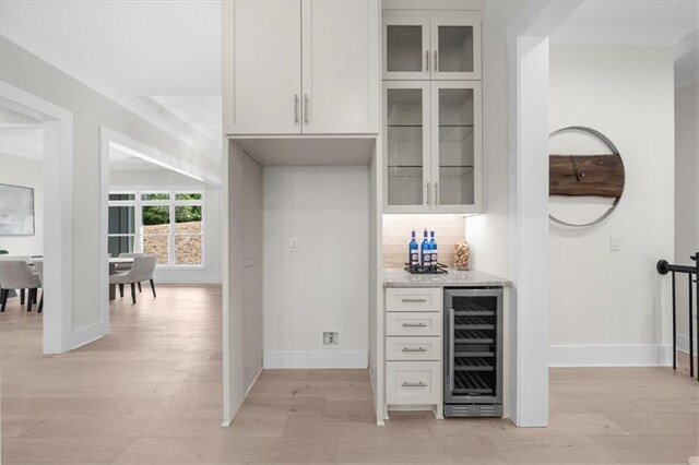 5990 Watermark Cv, Gainesville, GA 30506 - indoor dry bar featuring beverage cooler, light wood finished floors, and baseboards