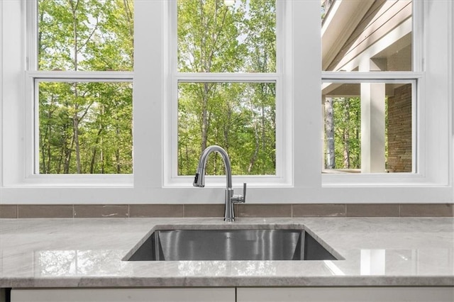 5990 Watermark Cv, Gainesville, GA 30506 - kitchen featuring a sink, light stone counters, white cabinets, and plenty of natural light