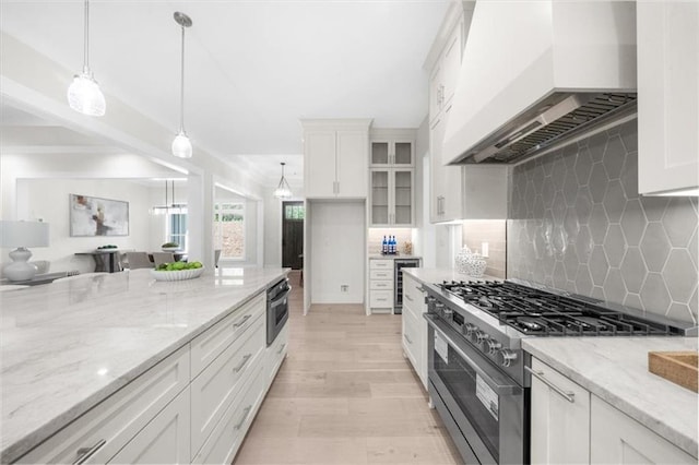 5990 Watermark Cv, Gainesville, GA 30506 - kitchen featuring premium range hood, appliances with stainless steel finishes, white cabinets, and light stone counters