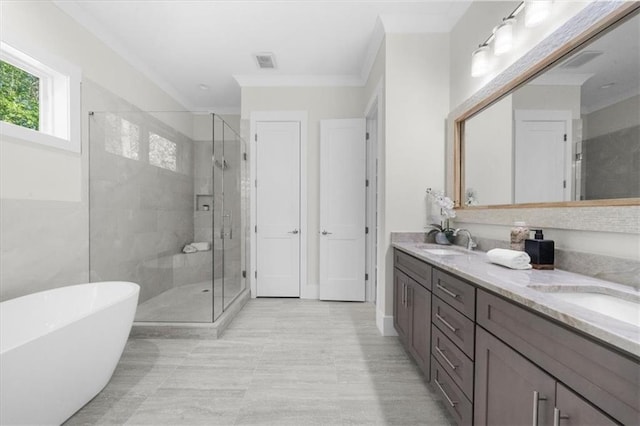 5990 Watermark Cv, Gainesville, GA 30506 - bathroom featuring a shower stall, double vanity, a freestanding tub, and ornamental molding