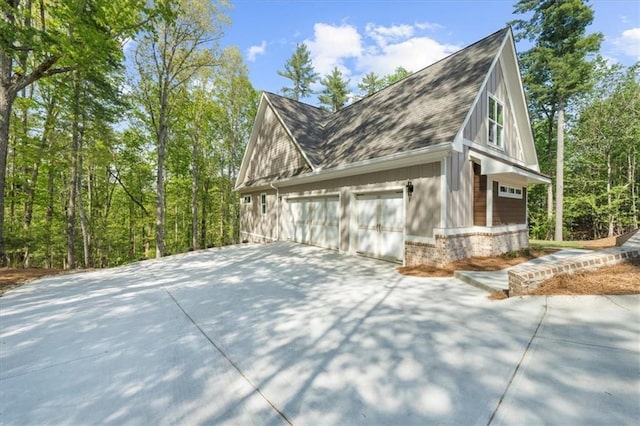 5990 Watermark Cv, Gainesville, GA 30506 - view of home's exterior with driveway, a shingled roof, a garage, and brick siding