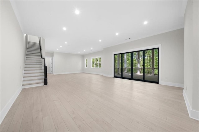 5990 Watermark Cv, Gainesville, GA 30506 - unfurnished living room with baseboards, light wood finished floors, recessed lighting, and stairway