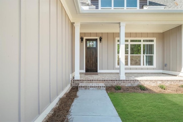 5990 Watermark Cv, Gainesville, GA 30506 - doorway to property featuring board and batten siding, covered porch, and a shingled roof
