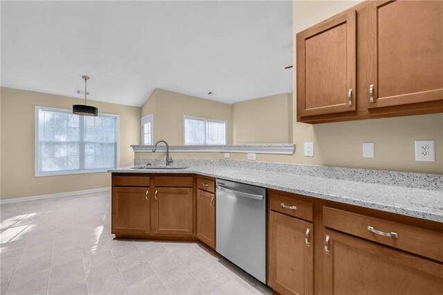 kitchen featuring sink, light stone counters, stainless steel dishwasher, pendant lighting, and light tile patterned floors