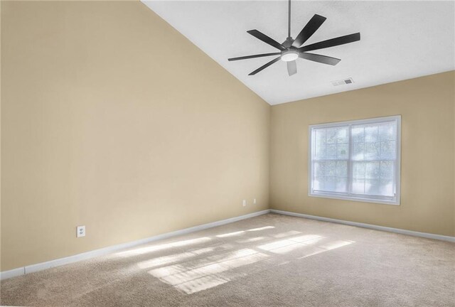 spare room with light carpet, vaulted ceiling, and ceiling fan