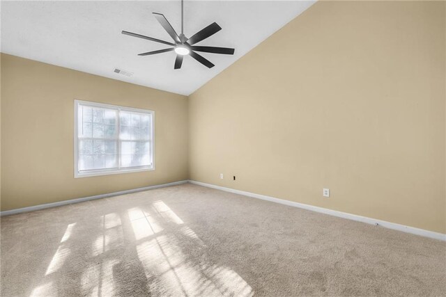 empty room with ceiling fan, light colored carpet, and lofted ceiling