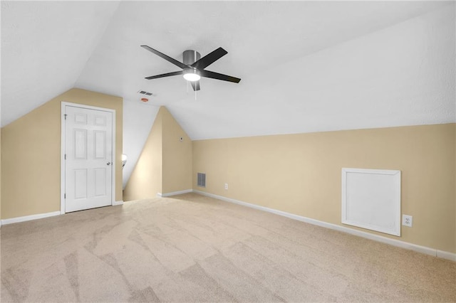 bonus room with light colored carpet, vaulted ceiling, and ceiling fan