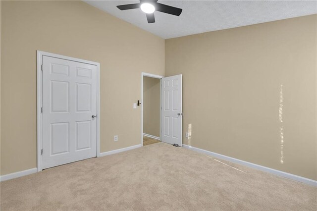 unfurnished bedroom featuring ceiling fan and light colored carpet