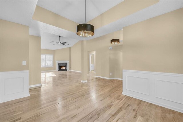 unfurnished living room featuring ceiling fan and light hardwood / wood-style floors