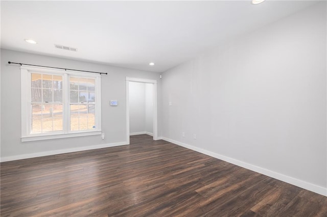 unfurnished room with dark hardwood / wood-style floors