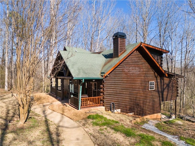 1225 Pitts Chapel, Newborn, GA 30056 - view of front facade with covered porch, a chimney, log exterior, and roof with shingles
