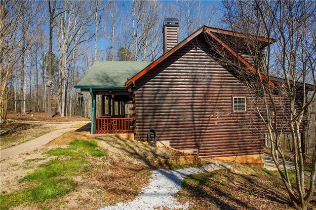 1225 Pitts Chapel, Newborn, GA 30056 - view of home's exterior with log exterior and a chimney