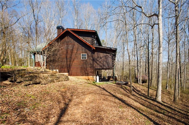 1225 Pitts Chapel, Newborn, GA 30056 - view of home's exterior featuring a chimney and log siding