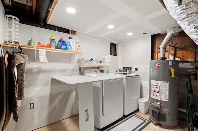 washroom featuring gas water heater, recessed lighting, laundry area, and washing machine and clothes dryer