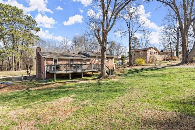 view of yard featuring fence and a wooden deck